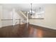 Spacious living room with hardwood floors, staircase, and dining area at 262 Bell Grove Ln, Suwanee, GA 30024