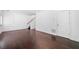 Living room featuring hardwood floors, stairs, and decorative wainscoting at 262 Bell Grove Ln, Suwanee, GA 30024