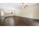 Open-concept living room with dark hardwood floors and views of the kitchen at 262 Bell Grove Ln, Suwanee, GA 30024
