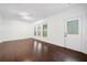 Living room featuring hardwood floors and multiple windows at 262 Bell Grove Ln, Suwanee, GA 30024
