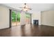 Bright living room features a fireplace, wood floors, ceiling fan, and access to the outdoor deck at 262 Bell Grove Ln, Suwanee, GA 30024