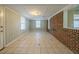 Spacious basement featuring tile floors, windows, and brick accent wall at 2693 Larkspur Se Dr, Atlanta, GA 30316