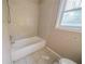 Bathroom with tiled walls, tiled floors, and a bathtub at 2693 Larkspur Se Dr, Atlanta, GA 30316