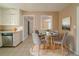 Cozy dining area with a glass table, neutral walls, and a view to the kitchen at 2693 Larkspur Se Dr, Atlanta, GA 30316