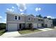 Attractive townhomes showcase attached garages, green lawns, and complementary color schemes at 307 Winton Way, Villa Rica, GA 30180