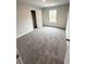 Spacious bedroom with neutral carpet, closet and natural light from the window at 45 Emerald Ln, Covington, GA 30014