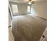 Spacious bedroom with carpet, a ceiling fan, and two large windows at 45 Emerald Ln, Covington, GA 30014