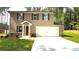 Charming two-story home with a fresh lawn and convenient two-car garage at 45 Emerald Ln, Covington, GA 30014
