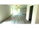 Open living room with laminate floors, ceiling fan and natural light from the windows at 45 Emerald Ln, Covington, GA 30014