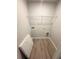 Walk-in pantry with laminate floors and wire shelving for storage at 45 Emerald Ln, Covington, GA 30014