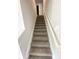 Carpeted staircase with white railing leading upstairs at 45 Emerald Ln, Covington, GA 30014