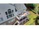 A detailed shot of the back of the home, featuring a large deck with outdoor seating at 5357 Harbury Cv, Suwanee, GA 30024