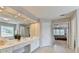 The primary bathroom features double sinks, vanity, large mirror, and access to the main bedroom at 5357 Harbury Cv, Suwanee, GA 30024