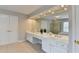 This bathroom features double sinks, vanity, and large mirror with great lighting at 5357 Harbury Cv, Suwanee, GA 30024