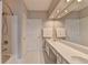 Bright bathroom with double sinks, large mirrors, and a tub shower at 5357 Harbury Cv, Suwanee, GA 30024