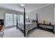 Serene bedroom with four-poster bed, soft carpet, and sunlit windows at 5357 Harbury Cv, Suwanee, GA 30024