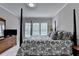 Comfortable bedroom with four-poster bed and soft natural light at 5357 Harbury Cv, Suwanee, GA 30024