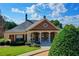 Exterior of the community clubhouse with decorative landscaping at 5357 Harbury Cv, Suwanee, GA 30024