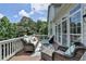 Outdoor deck with wicker furniture, many windows and a scenic view at 5357 Harbury Cv, Suwanee, GA 30024