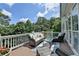 Outdoor deck featuring wicker furniture, a rug, and a beautiful view at 5357 Harbury Cv, Suwanee, GA 30024