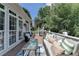 Outdoor deck with wicker furniture, grill and an American flag at 5357 Harbury Cv, Suwanee, GA 30024