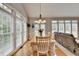 Sun-filled dining room featuring large windows and a lovely table setting at 5357 Harbury Cv, Suwanee, GA 30024