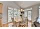 Charming dining area with a beautiful table setting and natural light at 5357 Harbury Cv, Suwanee, GA 30024