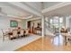 Inviting dining space featuring hardwood floors, tray ceilings, and views of the staircase and living area at 5357 Harbury Cv, Suwanee, GA 30024