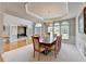 Spacious dining area featuring abundant natural light, tray ceilings, and open access to the adjoining living spaces at 5357 Harbury Cv, Suwanee, GA 30024
