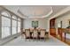 Formal dining room with carpet, chandelier, plenty of natural light, and built-in cabinets at 5357 Harbury Cv, Suwanee, GA 30024