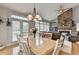 Elegant dining area with natural light, stone fireplace, and an open floor plan at 5357 Harbury Cv, Suwanee, GA 30024