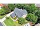 Aerial shot showcasing a home's roof, landscaping, and green lawn, highlighting the well-kept exterior at 5357 Harbury Cv, Suwanee, GA 30024