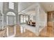 Inviting foyer featuring hardwood floors, grand pillars, and an open layout leading to the dining area at 5357 Harbury Cv, Suwanee, GA 30024