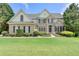 A beautiful two story home with brick facade, manicured lawn and mature landscaping at 5357 Harbury Cv, Suwanee, GA 30024