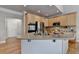 Open kitchen with light wood cabinets and stainless appliances at 5357 Harbury Cv, Suwanee, GA 30024