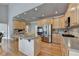 Spacious kitchen with stainless steel appliances, island, and hardwood floors at 5357 Harbury Cv, Suwanee, GA 30024