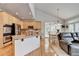Open kitchen with light wood cabinets, stainless appliances, and breakfast nook at 5357 Harbury Cv, Suwanee, GA 30024