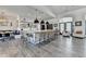 A spacious kitchen island with seating complements the open floor plan and modern decor at 5357 Harbury Cv, Suwanee, GA 30024
