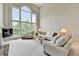Bright living room with soaring windows, fireplace and white furniture at 5357 Harbury Cv, Suwanee, GA 30024
