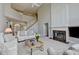 Open concept living room features fireplace, staircase and view of second level at 5357 Harbury Cv, Suwanee, GA 30024