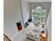 Bright living room with soaring ceilings, fireplace, and a large window letting in ample natural light at 5357 Harbury Cv, Suwanee, GA 30024