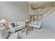 Open concept living room features white furniture, staircase and view of second level at 5357 Harbury Cv, Suwanee, GA 30024