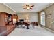 Functional home office with built-in shelving, an executive desk, and a cozy seating area at 5357 Harbury Cv, Suwanee, GA 30024