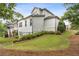 Landscaped backyard featuring a well-manicured lawn and lush greenery with nice home elevation at 10 Nesbit Reserve Ct, Atlanta, GA 30350