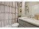 Bathroom featuring a granite vanity, ample cabinetry, and a decorative shower curtain at 10 Nesbit Reserve Ct, Atlanta, GA 30350