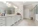 Bathroom featuring an expansive vanity, a frameless shower, and neutral color scheme at 10 Nesbit Reserve Ct, Atlanta, GA 30350