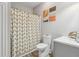Well-lit bathroom featuring a shower with a decorative curtain and modern fixtures at 10 Nesbit Reserve Ct, Atlanta, GA 30350