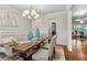 Well-lit dining room with dining table, chandelier, and wall art at 10 Nesbit Reserve Ct, Atlanta, GA 30350