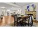 Dining room with stone fireplace, hardwood floors, and open concept to the kitchen at 10 Nesbit Reserve Ct, Atlanta, GA 30350