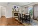 Dining room with stone fireplace, hardwood floors, and a view into the kitchen at 10 Nesbit Reserve Ct, Atlanta, GA 30350